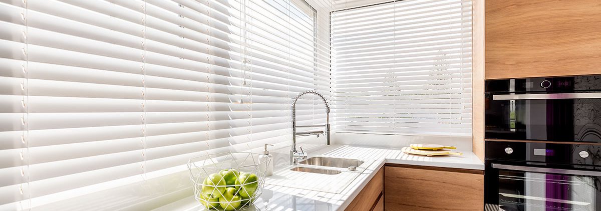 White Wooden Venetian Blinds in a kitchen