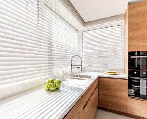 White Wooden Venetian Blinds in a kitchen