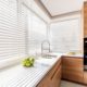 White Wooden Venetian Blinds in a kitchen